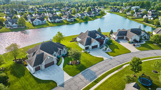 Aerial view of a residential street by a lake